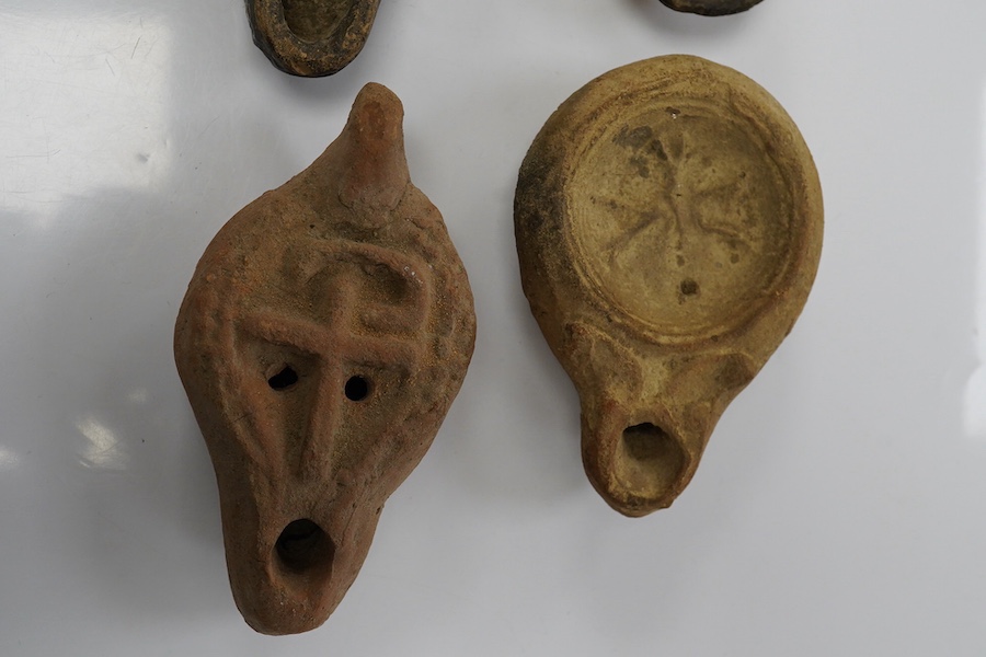 Six late Roman pottery lamps, three decorated with figures, including one with Christ in Majesty, and one decorated with the Chi Rho. Condition - fair to good.